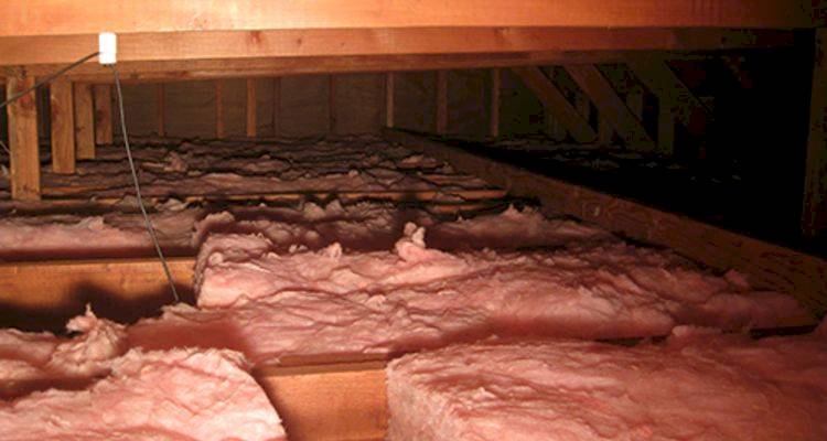 roof insulation cost guide — insulation that has been installed next to the joists of a UK loft