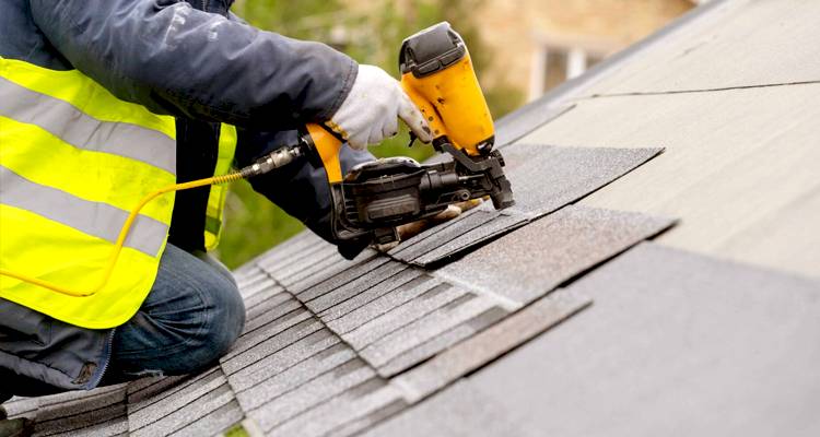 Tradesperson repairing a roof