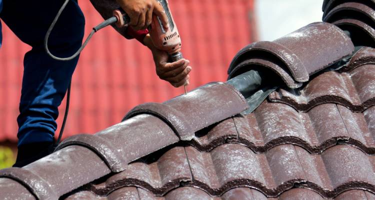 roofer fixing roof tiles