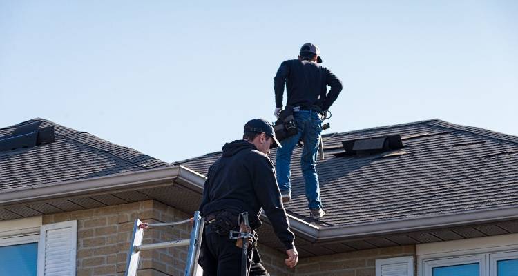 roofers inspecting roof