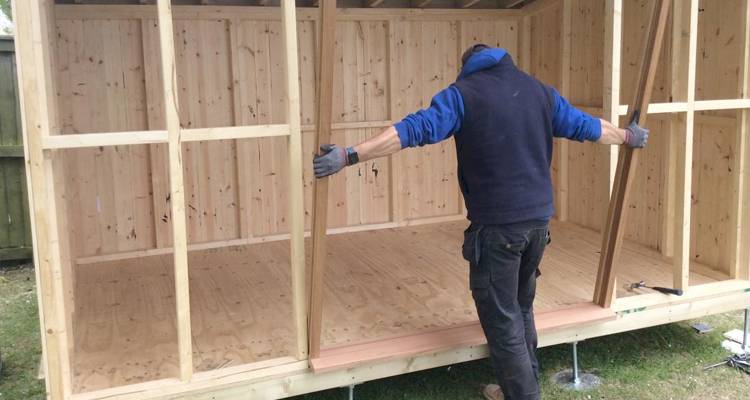 Man repairing a shed