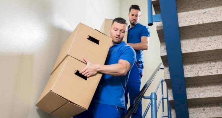 Men carrying boxes down stairs