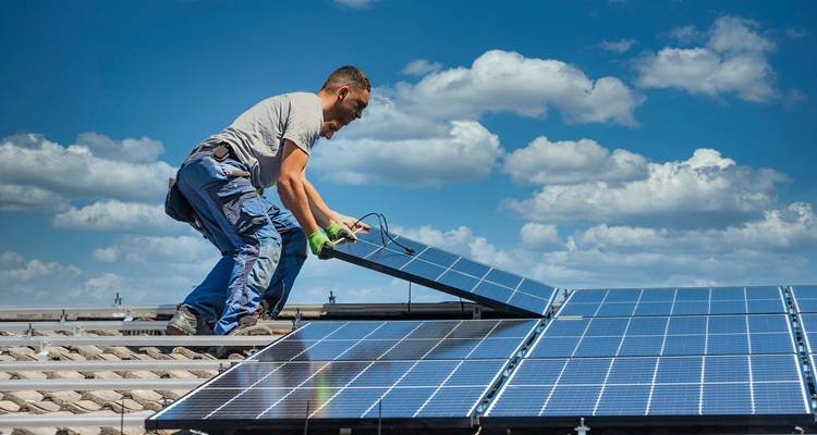 two workers fitting solar