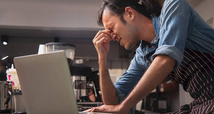 Stressed leaning over computer