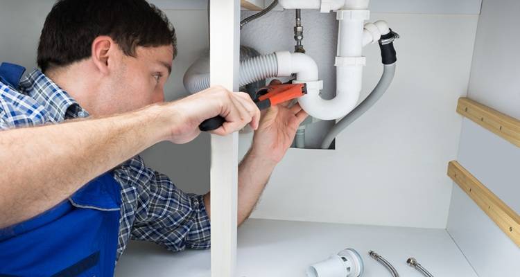 Plumber under sink