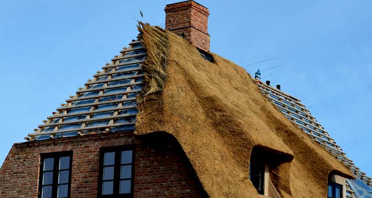 thatched roof installation that has been partially completed