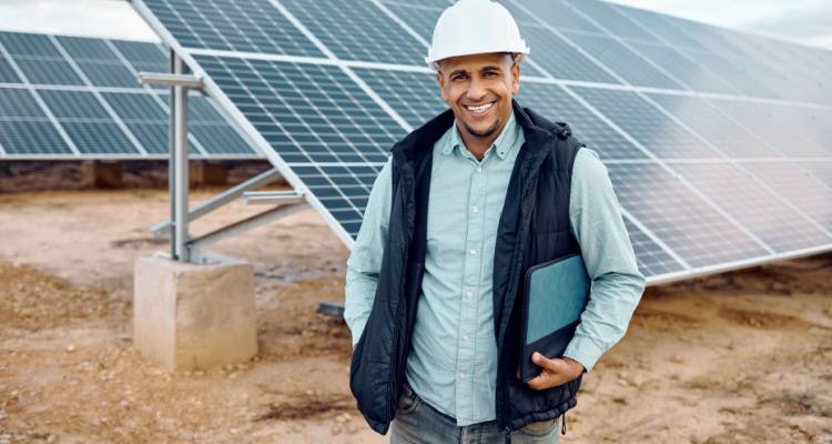 construction worker in front of solar panels