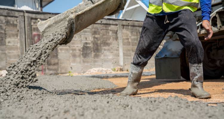 person pouring concrete