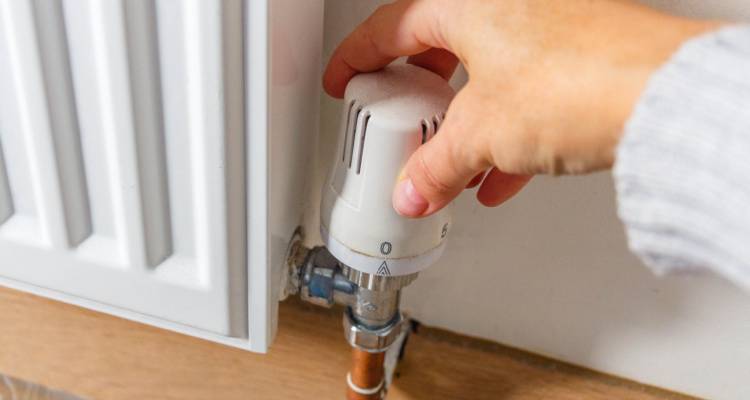 person turning down radiator