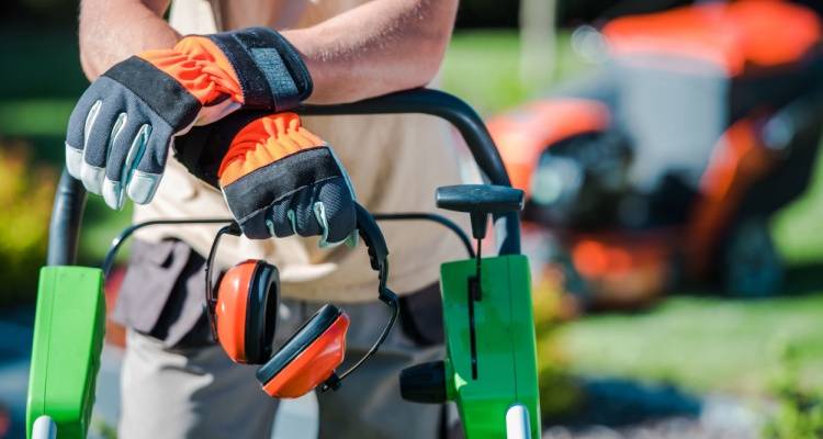 gardener with gloves and ear defenders