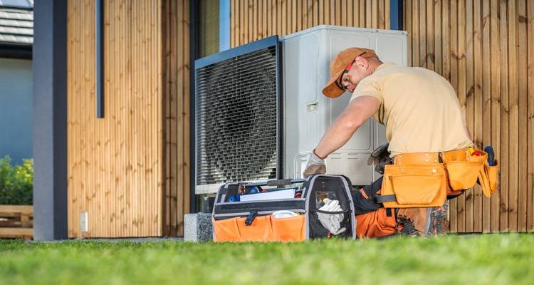 man installing heatpump