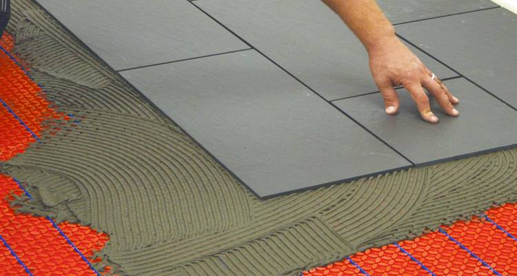Grey tiles above underfloor heating