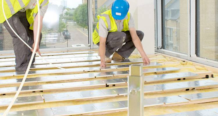 Tradespeople fitting underfloor heating