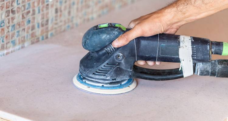 person sanding worktop