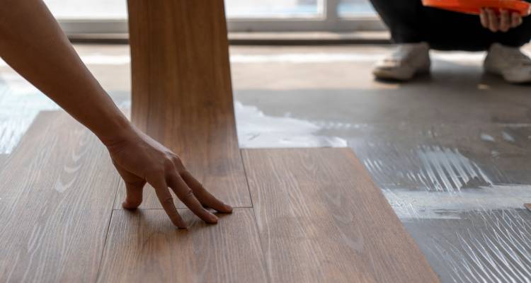 person installing a vinyl floor