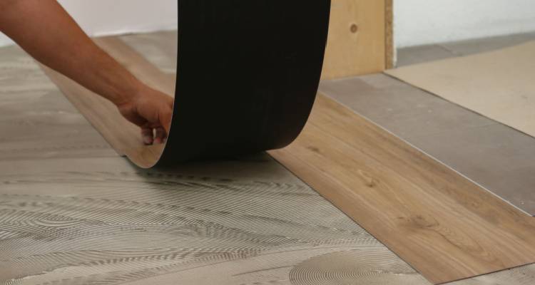 person fitting vinyl flooring
