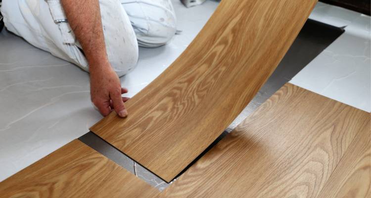 person installing vinyl flooring