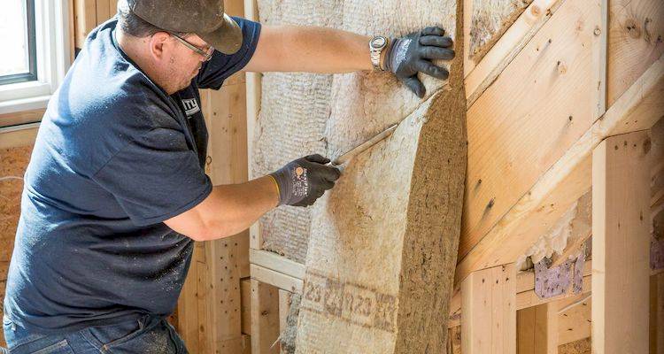 Man installing insulation