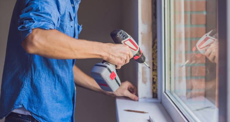 man fixing window