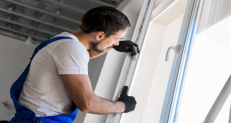 tradesperson fitting a new uPVC window