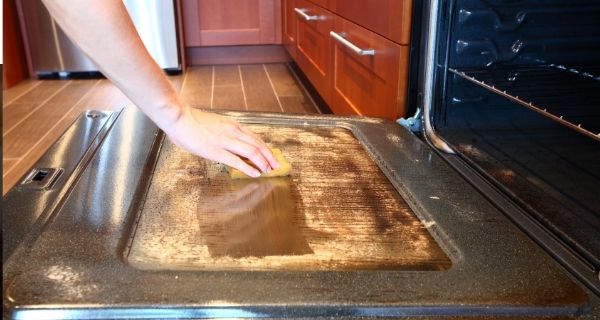 dirty oven being cleaned