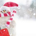 Snowman ready for snow with santa hat and show shovel