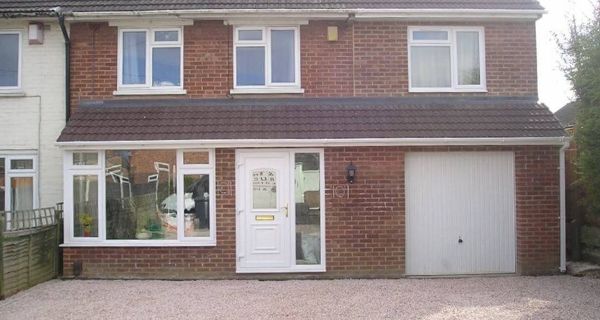 Front of house that has an extension across the full front