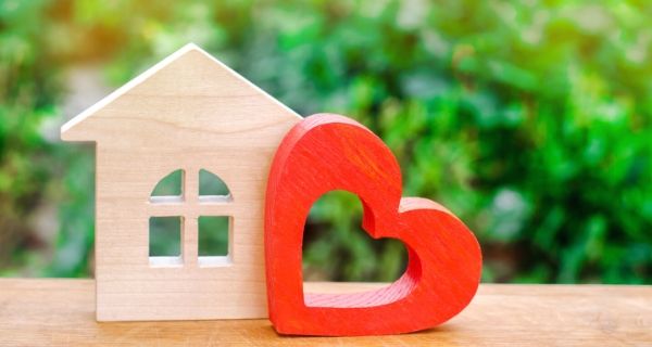 model wooden house and heart to represent loving your home.
