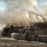 Storm wave breaking over a sea wall