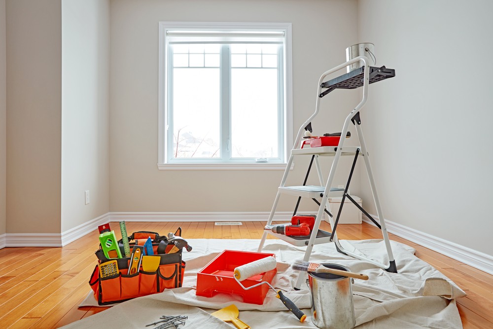 Empty room ready for you to hire a painter. Showing ladder and tools ready to do a professional job.