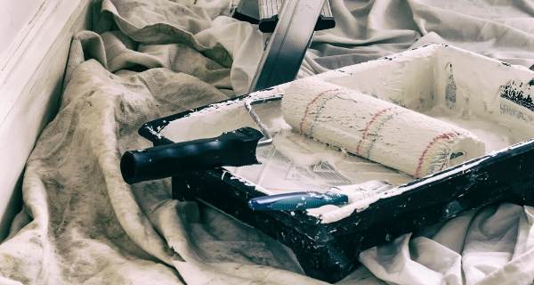 Dirty looking paint brush and roller for decorating