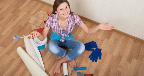 female say on floor with decorating tools around her