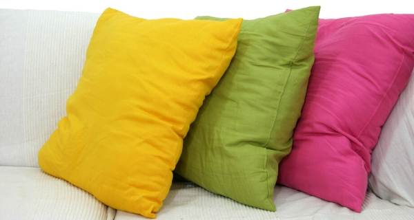 yellow green and pink cushions on sofa