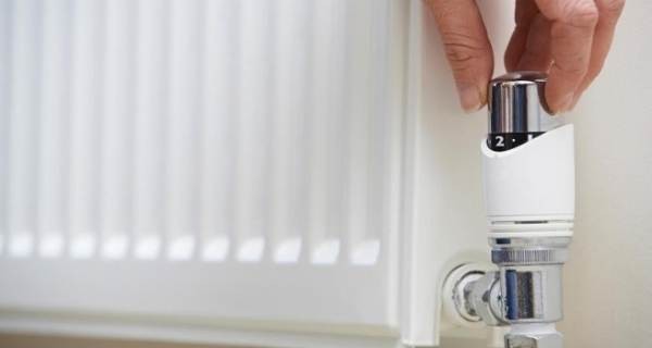 Hand adjusting the thermostat