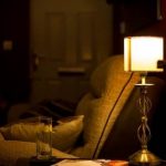 simple lamp next to chair in warm light lighting