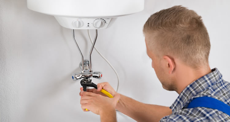 boiler being serviced by a heating engineer in the UK