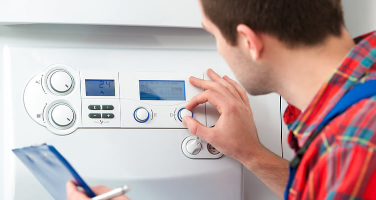 boiler installation cost guide — person using a boiler's control panel