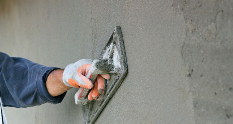 plasterer plastering a wall