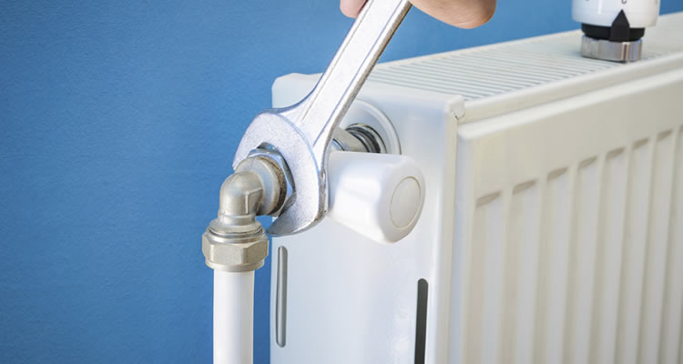 spanner and radiator on blue background