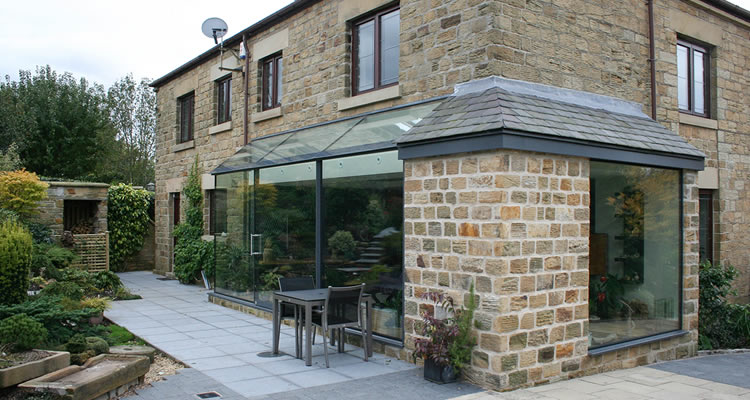 house extension cost guide — exterior view of a rear house extension on a UK home
